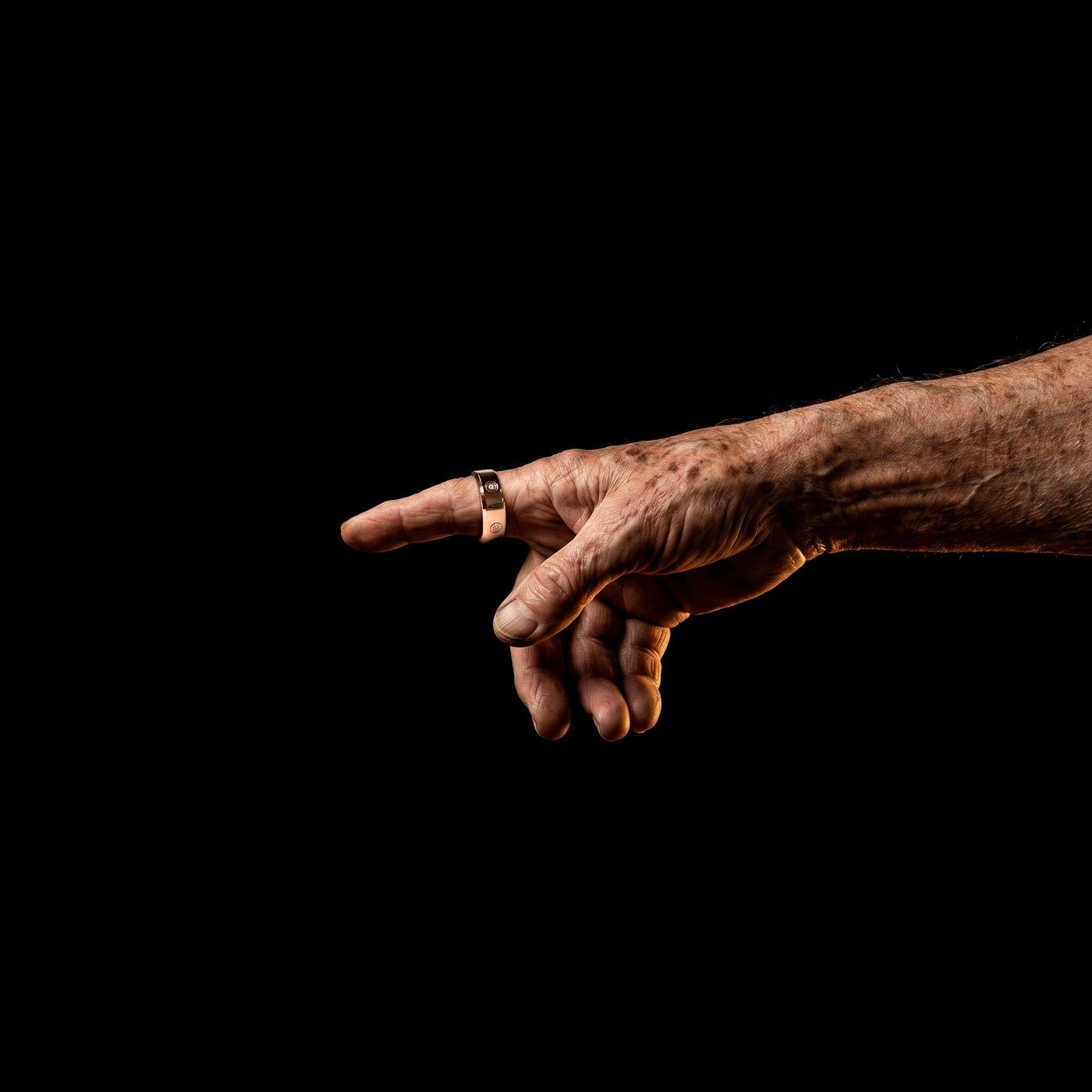 An older hand wearing the LuxenX ring, reaching back